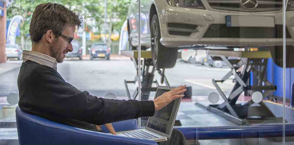 Customer using laptop in waiting area