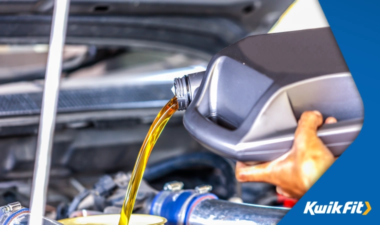 Engine oil being poured into a car.