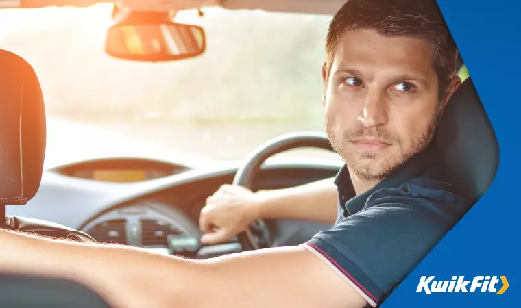 A driver practices driving manoeuvres in a safe place.