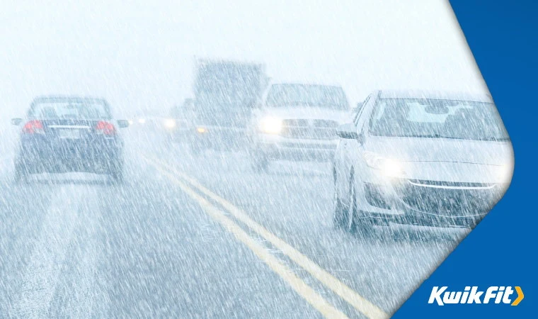 Cars driving in heavy snow.