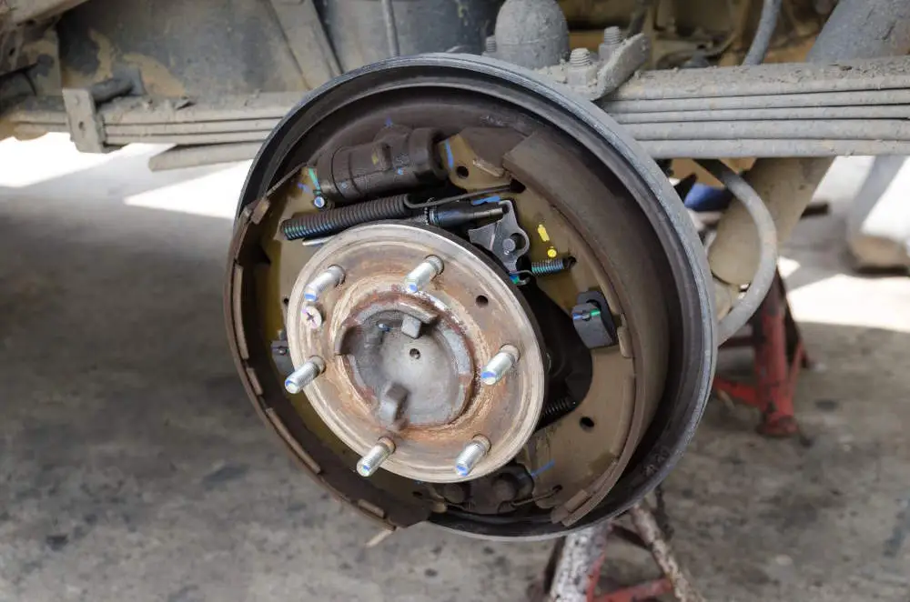 A drum brake on a vehicle in a workshop.