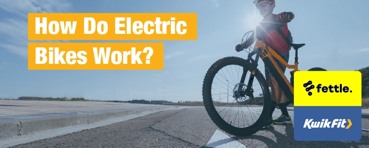 A person crossing a road with their electric bike.