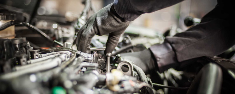 Mechanic working underneath the car bonnet