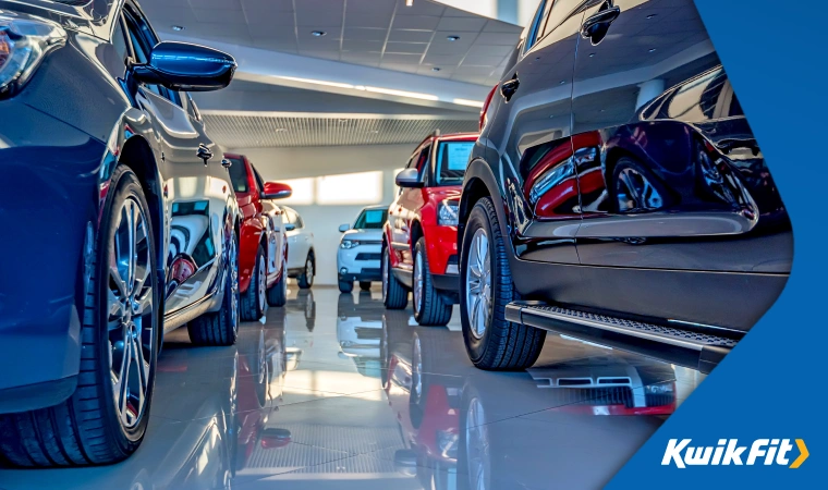 Shiny new cars in a dealer showroom.