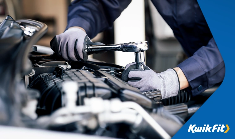 A mechanic doing maintenance work on a vehicle.