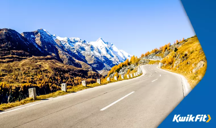 A road through the Alps with a view of Mont Blanc.