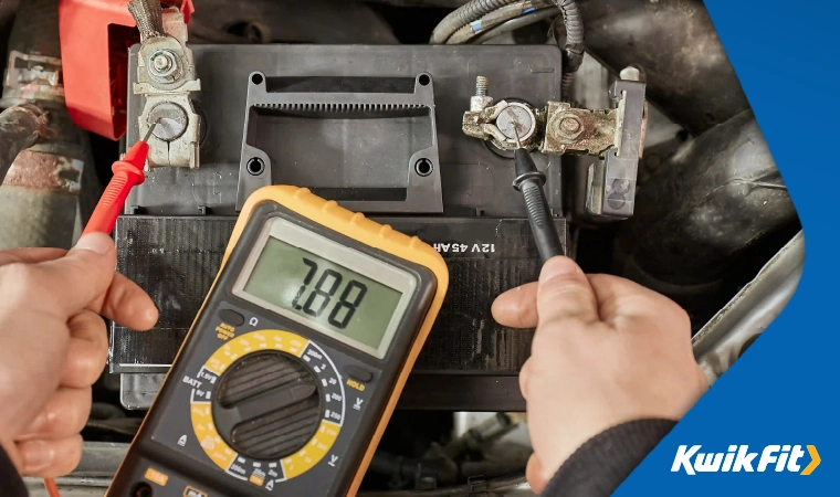 Testing the voltage of a car battery.