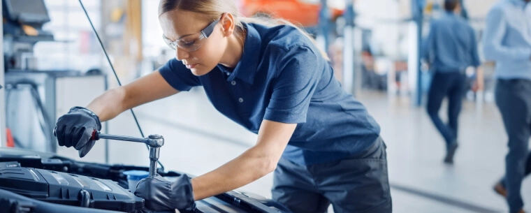 Woman inspecting car engine